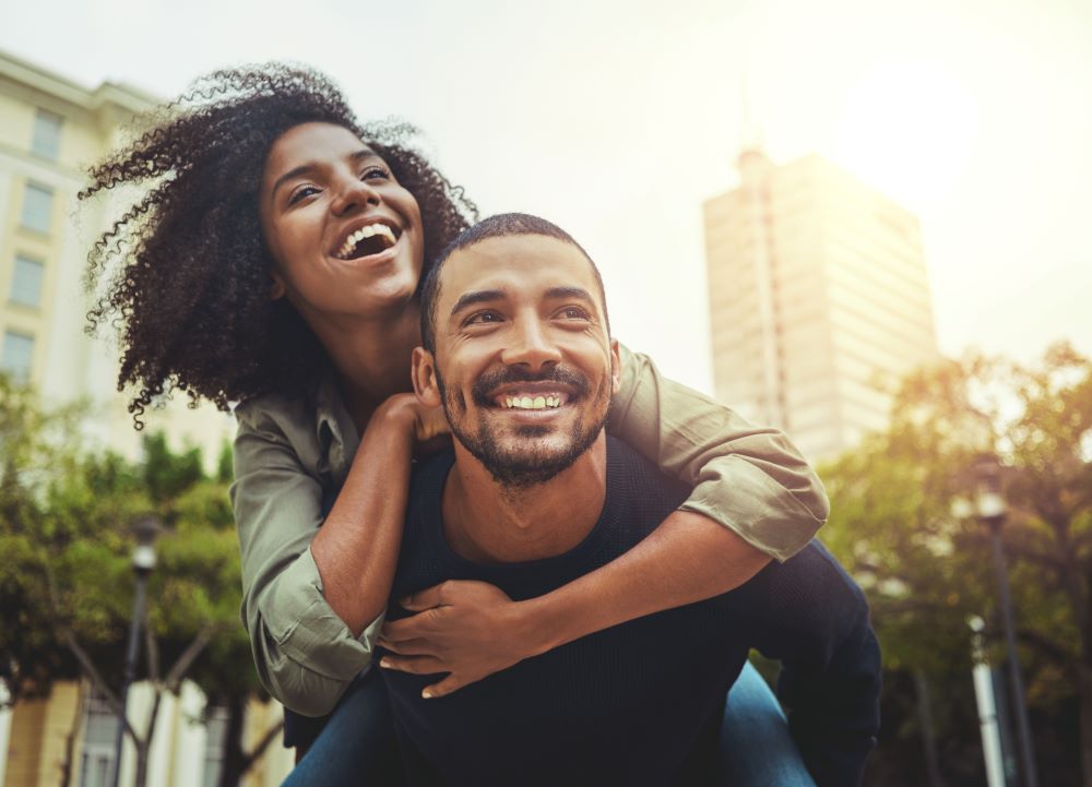 A young couple smiling and hugging, reflecting the advantage of RRSP contributions