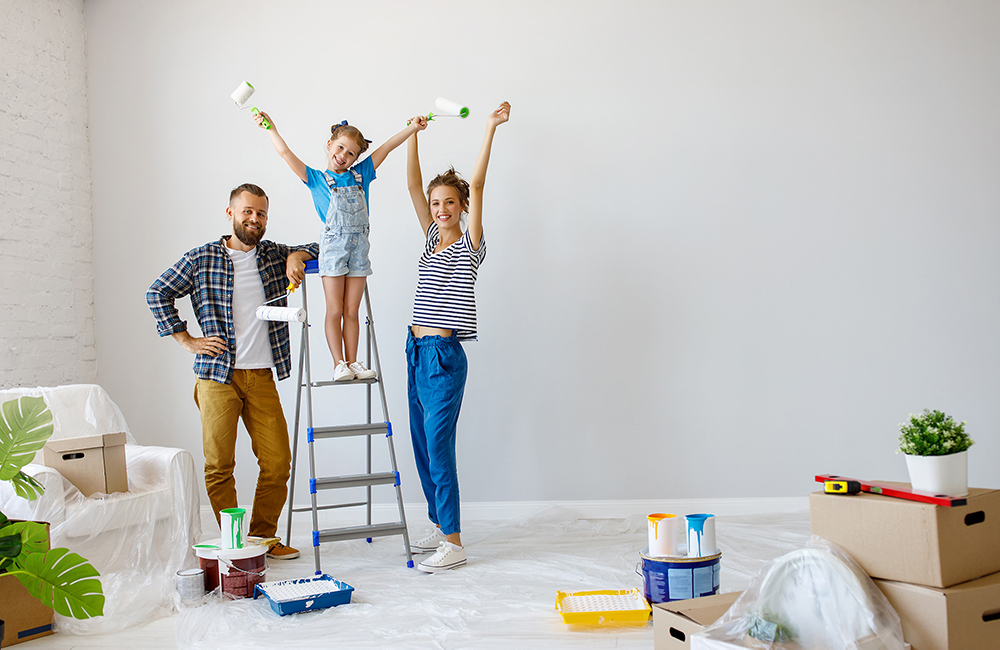 A young family excited to paint their new house which they bought thanks to recent mortgage changes in Canada