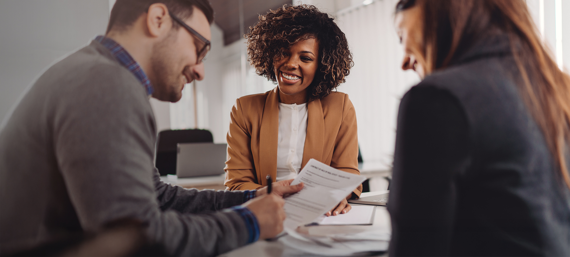 A couple meeting with a lending specialist about co-op & co-ownership housing financing